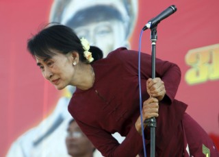 Aung San Suu Kyi speaks to supporters during a ceremony