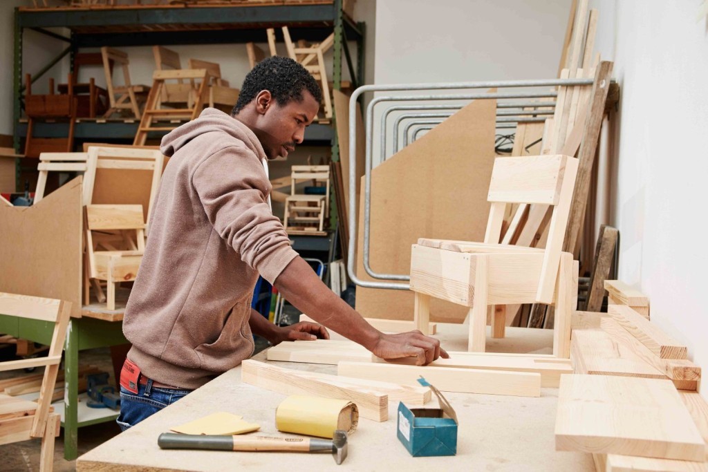 Ali Maiga Nouhou works on a child's chair at Cucula in Berlin