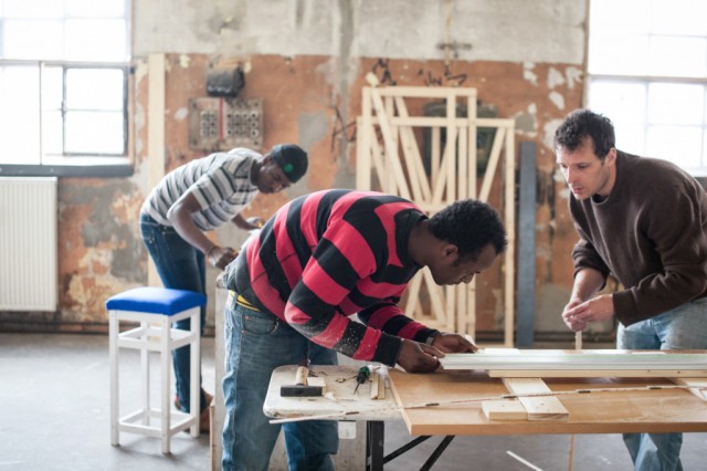 Two members of the Cucula team working on a piece of furniture