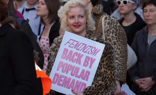 Campaigner holds a placard reading 