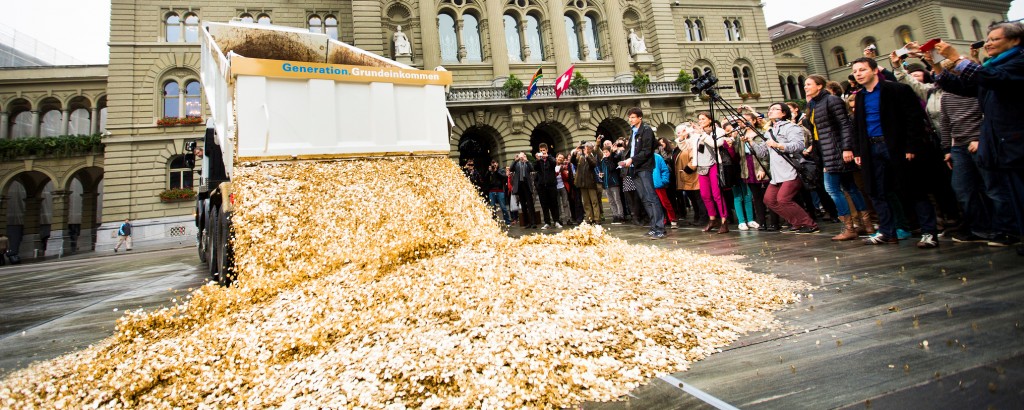 Swiss basic income advocates dump 8 million coins in a public square to celebrate the 125,000 signatures that forced the government to hold a referendum on the proposal in 2016.
