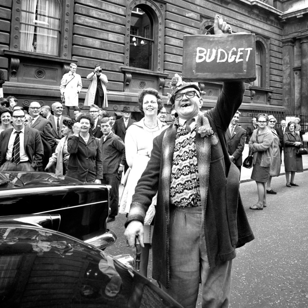 Ernest Stokes holds aloft a case with the word 'budget' written on it on budget day 1966 in London