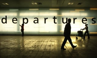 Passengers walk past a departures sign to the the new security block at Glasgow Airport, Glasgow.