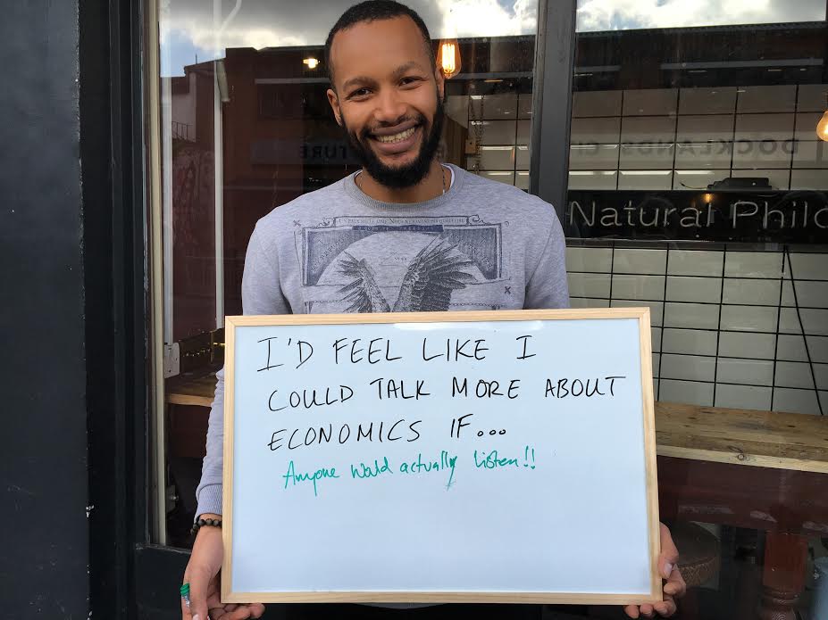 Dia holds a board that says: I'd feel like I could talk more about economics if...