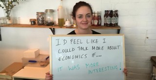 Hannah holds a board that says: I'd feel like I could talk more about economics if... it was more interesting!