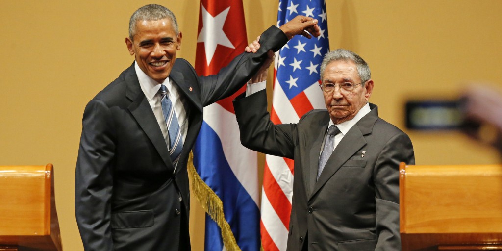Cuban President Raul Castro lifts U.S. President Barack Obama's arm after delivering speeches at the Palacio de la Revolucion in Havana, Cuba, on Monday, March 21, 2016