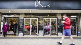 A person walks past a BHS store in Bristol, UK