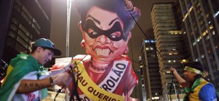 Protesters in Brazil inflate a giant effigy of former president Dilma Rousseff