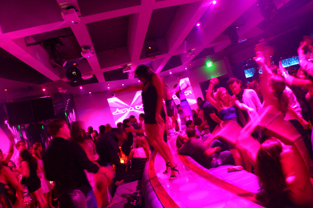 A woman dances on a bar in a nightclub