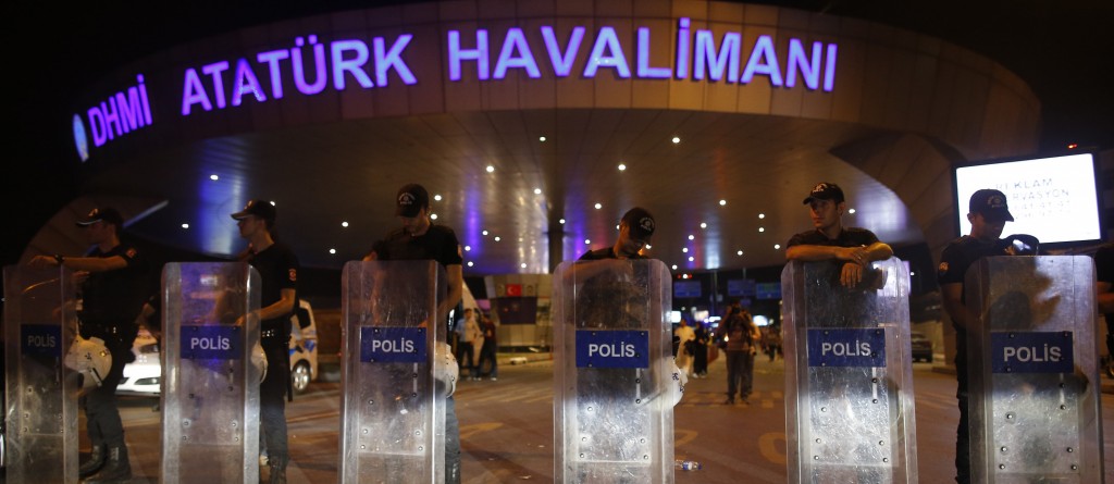 A line of police stand in front of Ataturk Airport in Turkey
