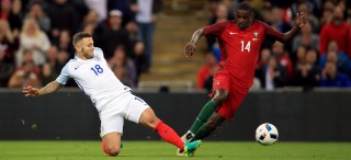 England's Jack Wilshere (left) and Portugal's William Carvalho battle for the ball