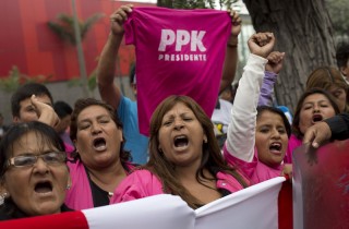 Voters in Peru hold a PPK T-shirt aloft