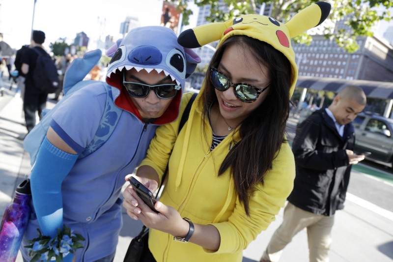 People costumed as the game's characters participate in a Pokemon Go search