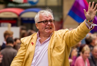 Christopher Biggins waves to crowds at Manchester Pride