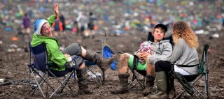 Festival goers in the aftermath of Glastonbury Festival, at Worthy Farm in Somerset.