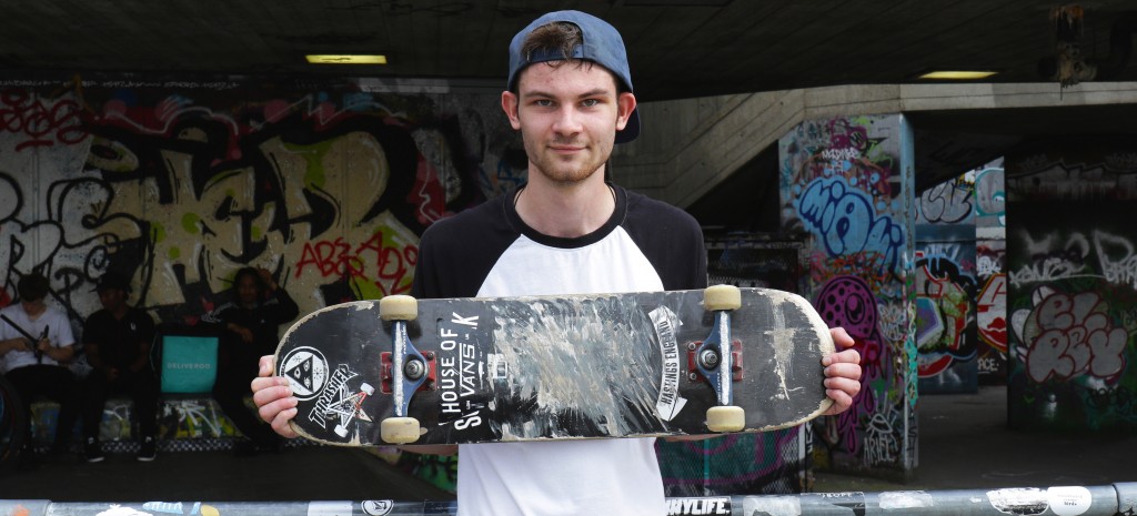 A skater stands with his board on the Southbank in London
