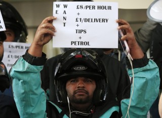 Deliveroo riders make wage demands during a protest outside the company offices in Torrington Place, Fitzrovia, London.