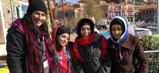 Author Elena Michael and three refugees
