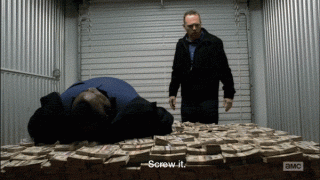 Breaking Bad characters Huell and Kuby lay down on a pile of money