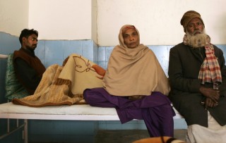 Shakel Ahmed, 28, left, whose kidney was removed, recovers at city civil hospital as his mother father sit near him, in Gurgaon, on the outskirts of New Delhi, India