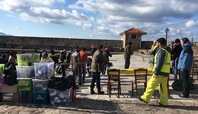 Volunteers organize supplies in the harbour in Lesvos