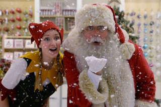 An elf and Santa at Selfridges Christmas Shop opening