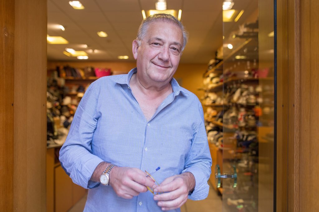 Man in front of shop in Greece.