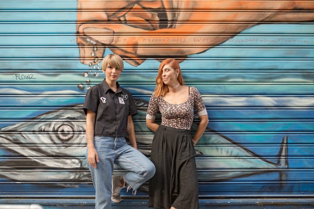 Two women in front of a garage in Greece.