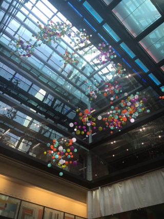 An atom sculpture suspended from the ceiling at the Bloomberg HQ in London