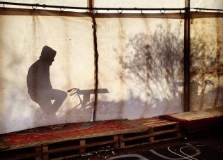 A man on a bike generates electricity at a refugee camp