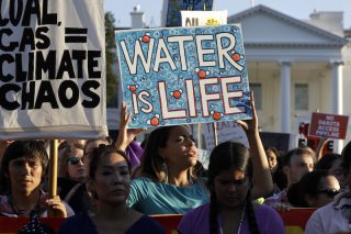 A protester holds up a sign that says 