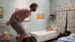 A man jumps on a bed