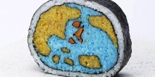 A piece of sushi with a pattern of the Earth sculpted into the rice