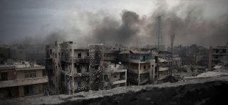 Smoke rises over Saif Al Dawla district, in Aleppo, Syria.