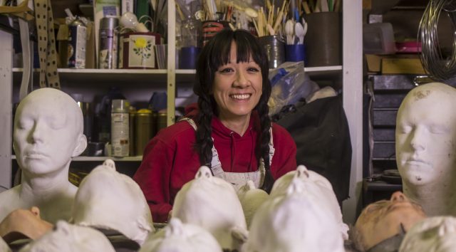 Natasha sits with her plaster cast heads