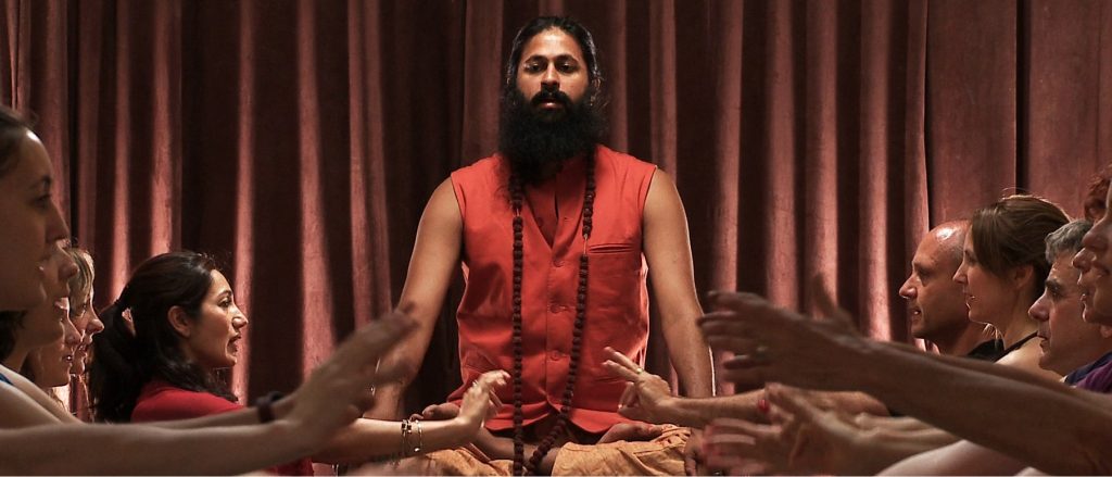 Self-declared yogi Kumare leads a class.