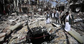 Members of Higher Council for Civilian Community Organization, inspect a destroyed funeral hall as they protest against a deadly Saudi-led airstrike on a funeral hall six days ago, in Sanaa, Yemen