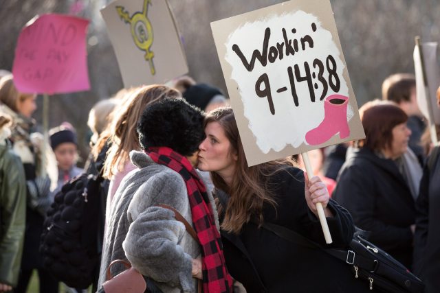 Icelandic protester with sign reading 