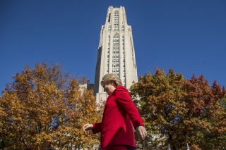 Hillary Clinton walking in front of the citadel of learning in Pittsburgh