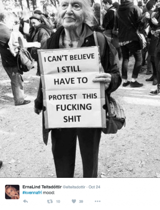 Woman holding sign saying 