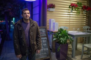 Man in front of shop