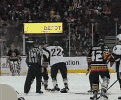 Hockey players hugging after fight