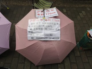 Mr Zhang's umbrella at the Shanghai marriage market.