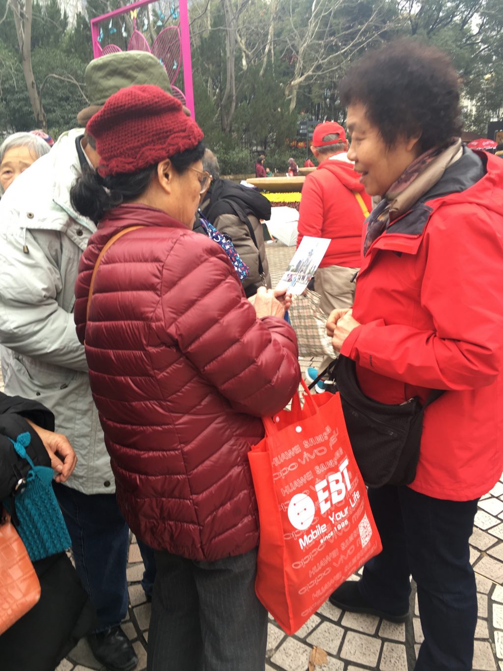 Parents compare photos of their children at Shanghai marriage markets.