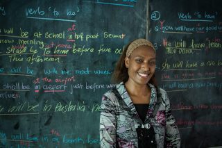 Grade 11 teacher Annette teaches English to her students  at Nor