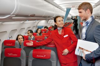 Austrian_Airlines_flight_attendant_and_passenger