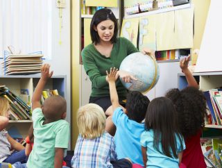 24488743 - elementary pupils in geography class with teacher