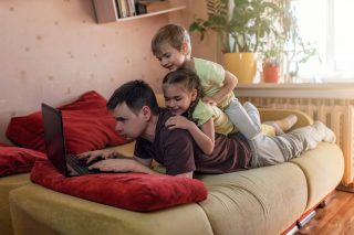 happy-man-with-children-using-laptop-and-earphone-during-his-home-working-life-in-quarantine-mobile_t20_pLykZd