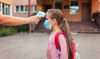 back-to-school-teacher-measuring-temperature-with-non-contact-thermometer-medical-mask-safety_t20_P0eW4p