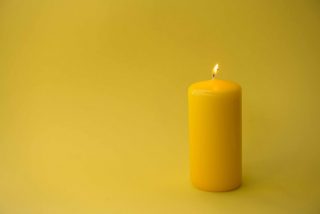 yellow-candle-isolated-on-yellow-background-holocaust-remembrance-day-background-black-bright-burn_t20_nRgQm4